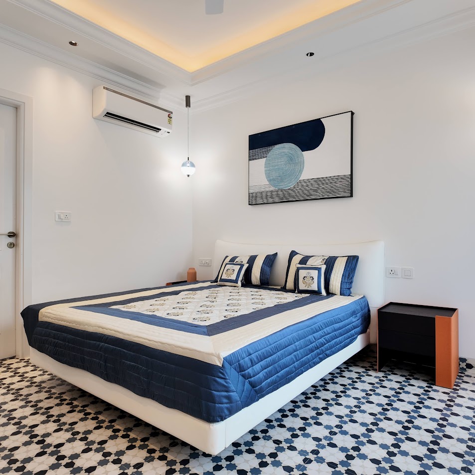 Florreta, Parra — blue-and-white bedroom with pendant lighting and patterned tile floor