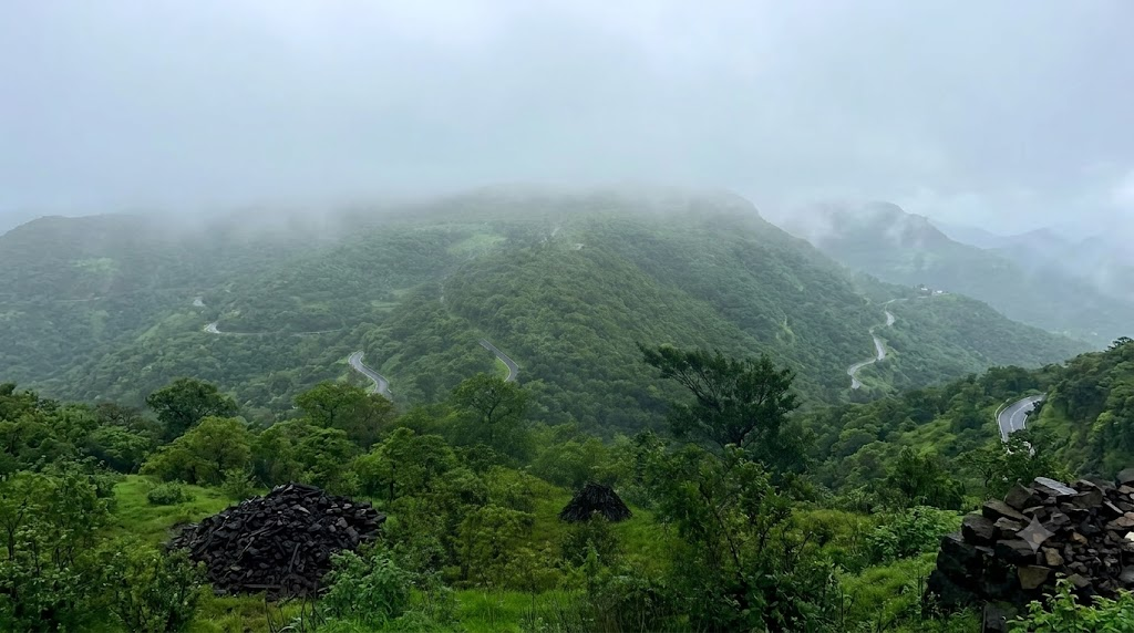 Misty monsoon hills and winding road in the Dodamarg landscape