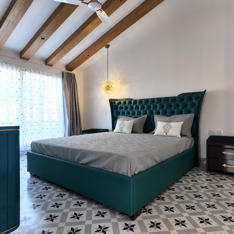 Florreta, Parra — green upholstered bedroom with timber ceiling beams, pendant light and patterned tile floor